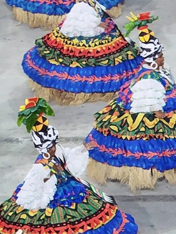 Samba dancers in big, colorful skirts at a carnival parade