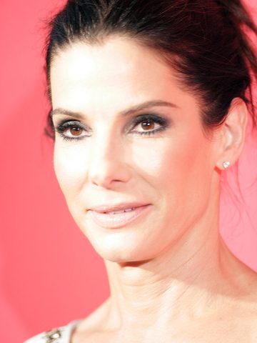 Sandra Bullock in front of a pink wall