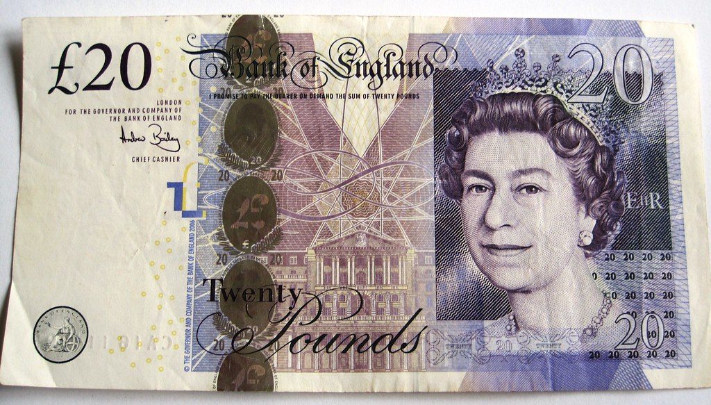 A British twenty-pound note with the pound symbol and the number 20