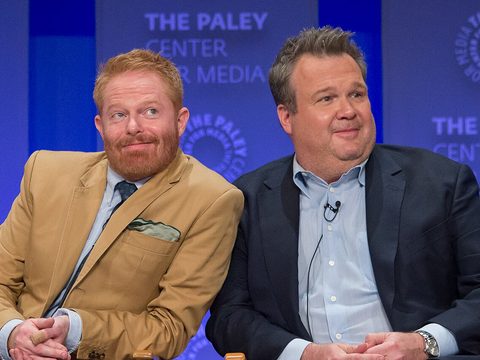 Actors Jesse Tyler Ferguson and Eric Stonestreet sitting side by side on a stage