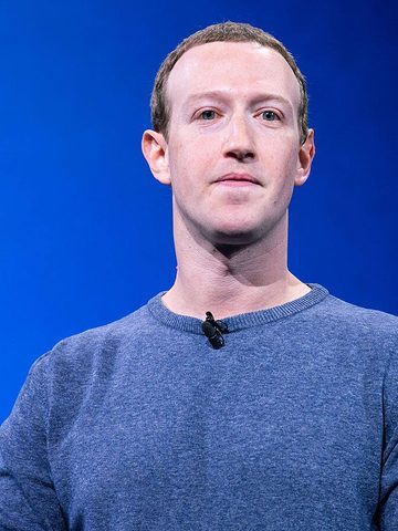 Mark Zuckerberg on a stage in a blue sweater