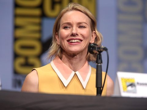 Actress Naomi Watts smiling in front of a microphone