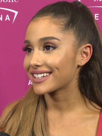 Ariana Grande smiling, with her long ponytail