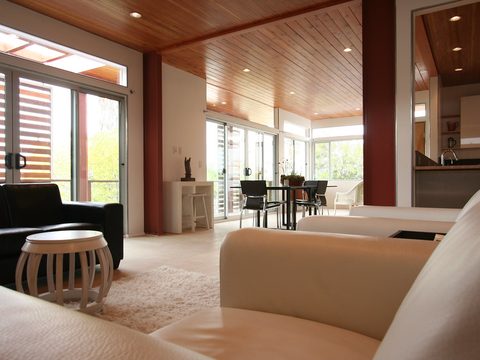 A living room with a black sofa and a white sofa